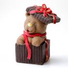 A delicious little teddy bear in a gift box in decorated chocolate