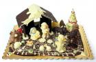 A Nativity scene in chocolate or in sugar with Jesus, Joseph and Maria in the stable, the ox, the donkey and the Three Wise Men