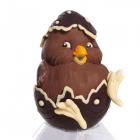 A little chick in white milk chocolate still in his shell made of dark fondant chocolate