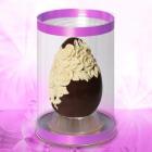 An Easter Egg in dark fondant chocolate with a decoration of roses in white milk chocolate in relief, presented in a transparent box