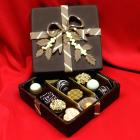 artistic chocolate in shape of a chocolate box filled with assortment of fine pralines.